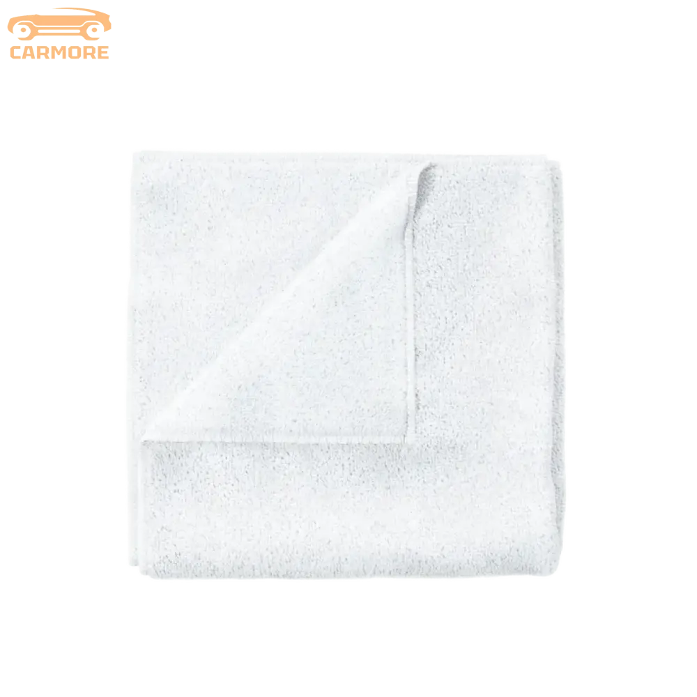 White soft cotton towel folded on a clean white background