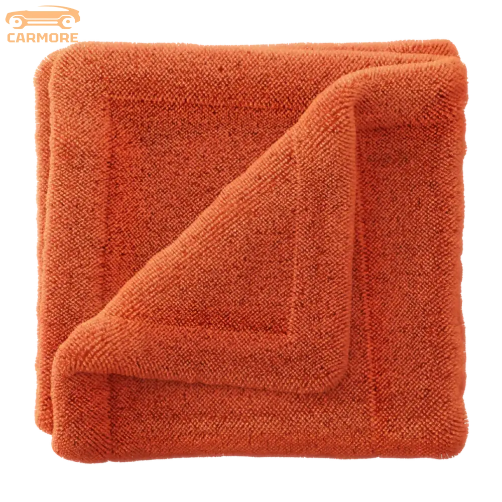 Soft orange microfiber towel folded with a textured terry cloth surface