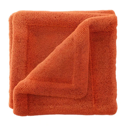Soft orange microfiber towel folded with a textured terry cloth surface