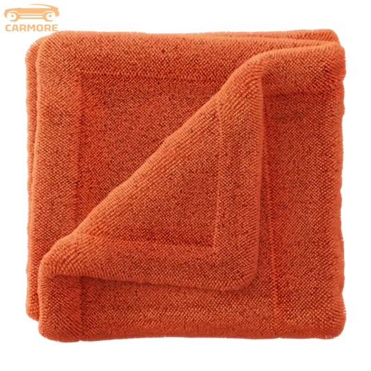 Soft orange microfiber towel folded with a textured terry cloth surface