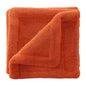 Soft orange microfiber towel folded with a textured terry cloth surface