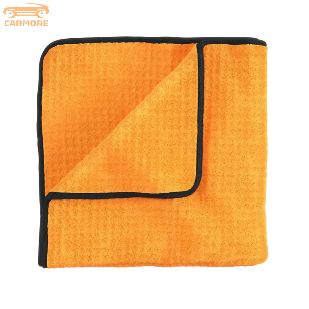 Orange microfiber cleaning towel with black edge trim, folded showing textured surface