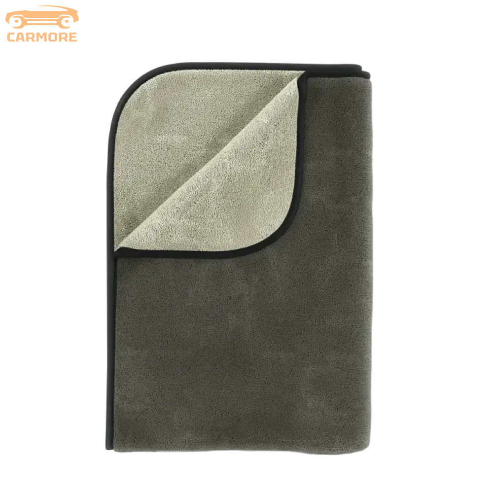 Folded microfiber towel in muted gray and light gray with black trim