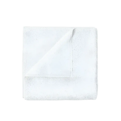 White soft cotton towel folded on a clean white background