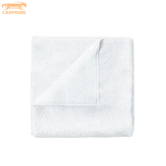 White soft cotton towel folded on a clean white background