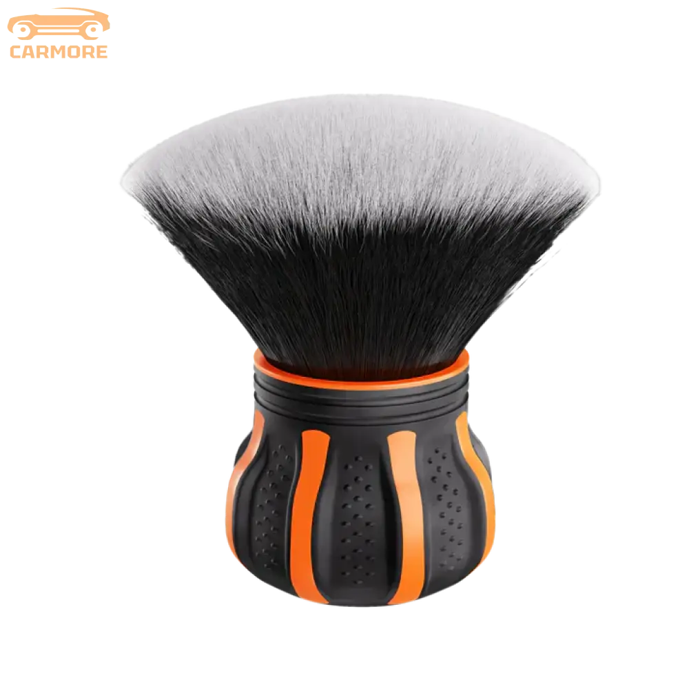 Black and orange makeup brush with dense, soft bristles and ergonomic handle