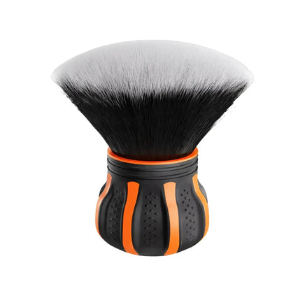 Black and orange makeup brush with dense, soft bristles and ergonomic handle