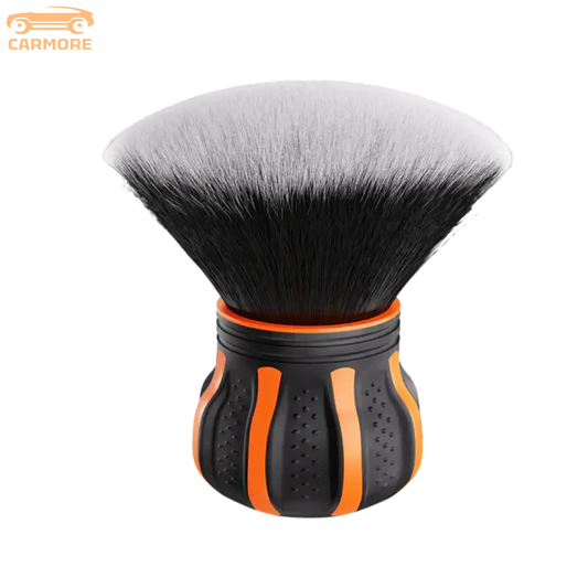 Black and orange makeup brush with dense, soft bristles and ergonomic handle